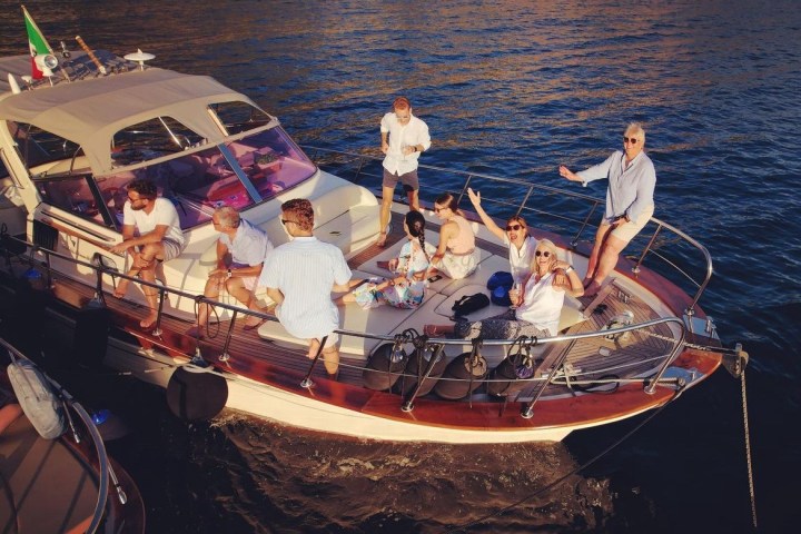 Group of people enjoying on a yacht in sunny weather.